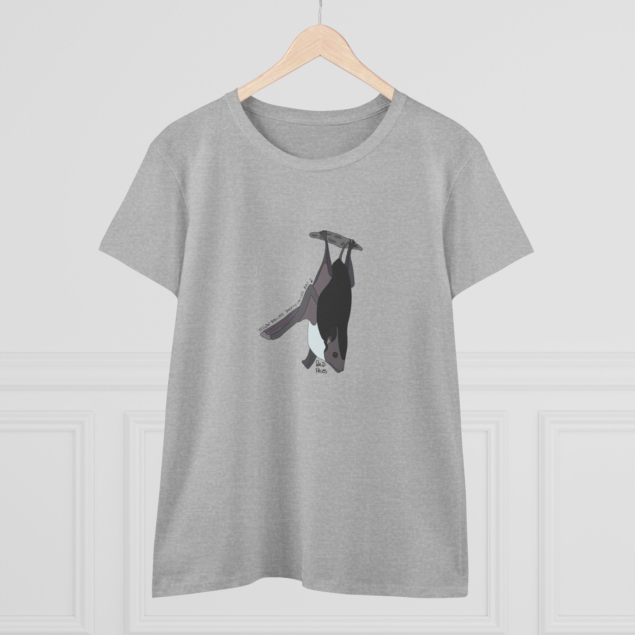 Small yellow-bellied sheath-tailed bat hangs on a womens shirt